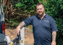 Staff member assisting with mobility support equipment