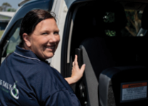 Driver opening vehicle door for passenger pickup