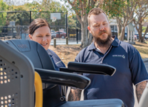Staff assisting passenger with accessible transport vehicle