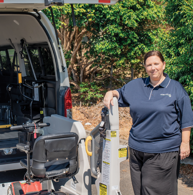 Mobility driver next to a wheelchair-accessible vehicle, reinforcing clear and dependable pricing for accessible transport.